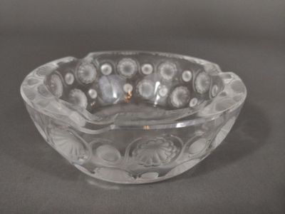 a clear glass bowl with flowers in it on a table