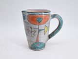 a coffee cup with a design on it on a white surface