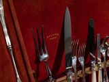 a lot of silverware in a case on the table