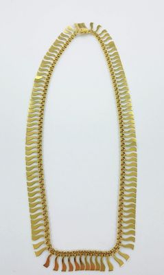 un collier en or sur fond blanc