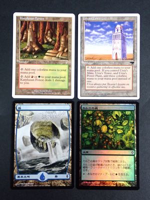 four different cards are shown on a table with a clock tower in the background