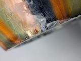 a close up of a piece of glass with a black substance on it