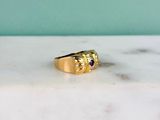 a picture of a gold ring with a garnett on it