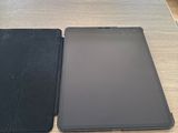 two tablet computers sitting on a table next to each other