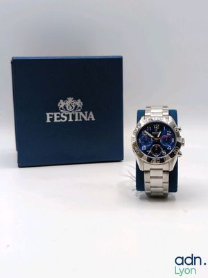 an image of a watch sitting next to a box on a white surface