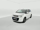 the small white car is parked in a white room