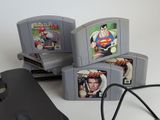 three nintendo game consoles sitting next to each other on a table