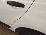 a close up of a white car with a black door handle