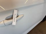 a ruler on the hood of a car that has been painted white