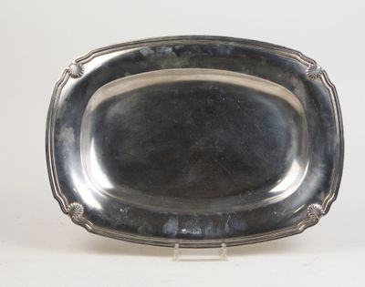 an antique silver plate on a stand on a white surface