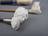 a statue of a man with a beard and a pipe
