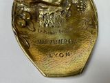 a gold plate with a picture of a man on it
