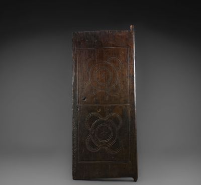 an old wooden door with a carved design on the front