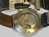 a close up of a watch on a white surface