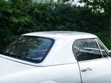 a white car that is parked on the side of the road