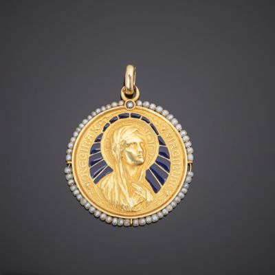 a gold and pearl pendant with an image of jesus