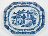 une assiette bleue et blanche ornée d'un paysage