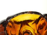 a close up of a glass object with a dog on it