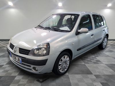 a picture of a small silver car parked in a garage