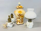 three vases and a lamp on a table
