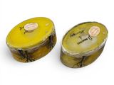 pair of yellow and white boxes with writing on them on a white surface