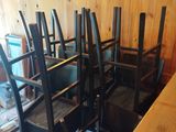 tables and chairs in a room with wood paneled walls