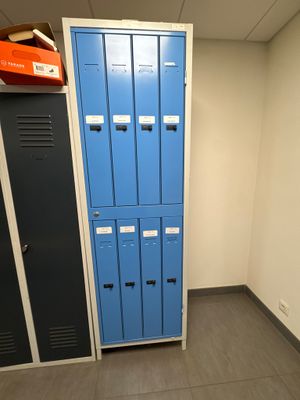 two blue lockers in the corner of a room next to each other