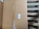 boxes are stacked on pallets in a warehouse with a sticker on them