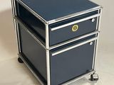 a metal cart with three drawers on wheels
