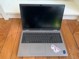 an open laptop computer sitting on top of a wooden floor