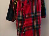 red and black plaid coat on a mannequin stand
