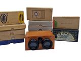 several boxes of different types of binoculars are stacked on top of each other