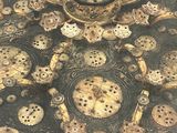 a close up of a gold plate with gears and gears on it