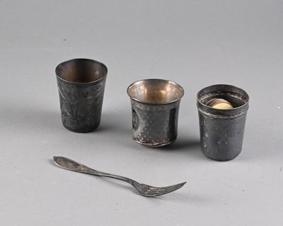 three cups and a spoon sitting next to each other