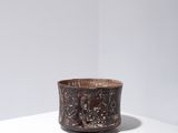 an image of a brown cup sitting on top of a white table