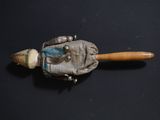 a small wooden stick with a metal object on it