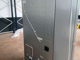 an image of a large metal refrigerator in a warehouse