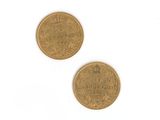 two gold coins on a white surface with a white background