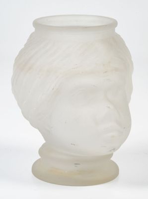 a white vase with a face on it on a white surface