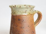 a close up of a coffee mug on a white surface