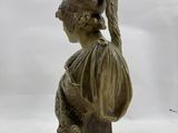 statue of a woman with a helmet and a snake on her head