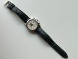 an image of a watch on a white surface with a black strap