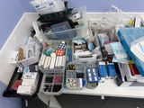 a desk with a lot of office supplies on top of it