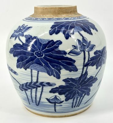 a blue and white vase with flowers and leaves on it