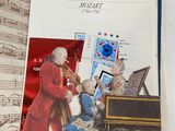 a picture of a book with a picture of a man playing the violin