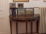 a table with pictures on it in a room with a radiator