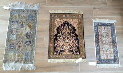 several rugs are laid out on the floor on a wooden floor