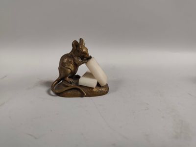 two figurines of a cat and a mouse on a white surface