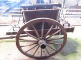 an old wooden wagon with a chain attached to it