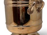 a gold ice bucket with a dragon handle on it
